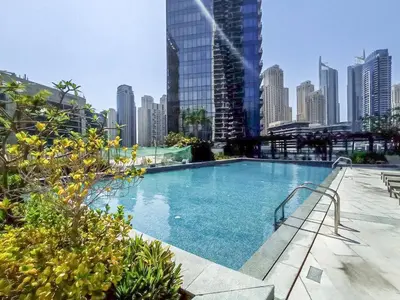 a large swimming pool in the middle of a city at Prime Stylish Studio with Marina Views in Dubai