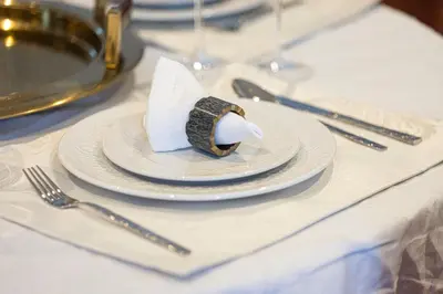 a white plate with a piece of cake on a table at The Suite Dubai 15 Northside Luxury Living in Dubai