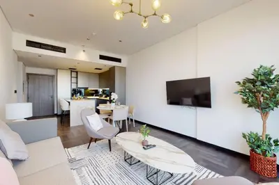 a living room with a couch and a table at O Ten, Al Jaddaf - Smart One Bedroom in Dubai