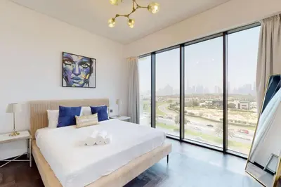 a bedroom with a large white bed and large windows at O Ten, Al Jaddaf - Smart One Bedroom in Dubai