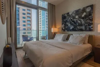 a bedroom with a large bed and a large window at Maison de Luxe - Jumeirah Living Marina Gate in Dubai
