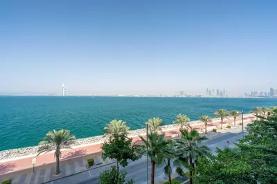 a view of the ocean from the balcony of a building at GuestReady - Burj Al Arab view at Royal Amwaj in Dubai