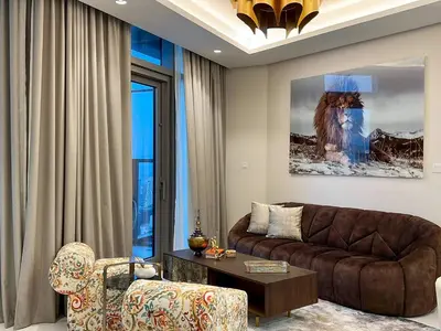 a living room with a couch and a chair at Keyrock Living - Burj Khalifa View Retreat with Pool in Dubai