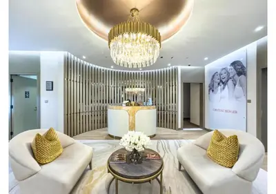 a living room with two white chairs and a chandelier at Keyrock Living - Burj Khalifa View Retreat with Pool in Dubai