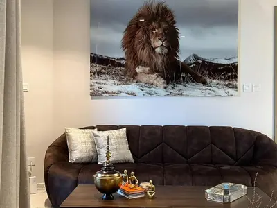 a living room with a lion painting on the wall at Keyrock Living - Burj Khalifa View Retreat with Pool in Dubai