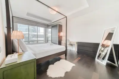 a bedroom with a large bed and a mirror at Limestone House, Dubai International Financial Centre - Mint Stay in Dubai