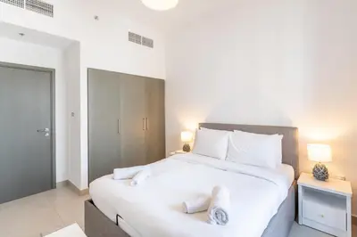 a bedroom with a large white bed with two pillows at Spacious 2 Bedroom on High Floor in Creek Horizon - Allsopp&Allsopp in Dubai