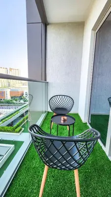 a chair and a table on a balcony at STAY BY LATINEM Luxury 2BR Holiday Home CV B601 near Burj Khalifa in Dubai