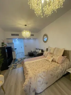 a bedroom with a large bed and a living room at Diamond Tower Marina Apartment in Dubai