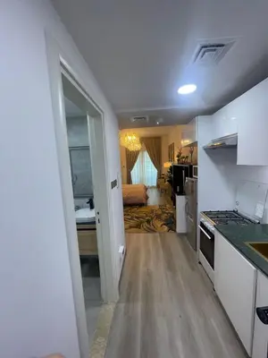 a room with a kitchen and a living room at Diamond Tower Marina Apartment in Dubai