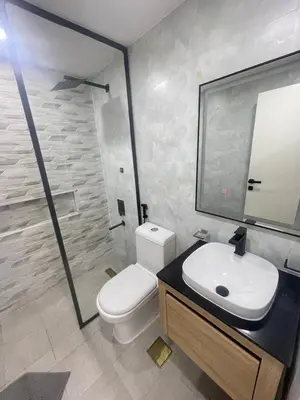 a bathroom with a toilet and a sink and a mirror at Diamond Tower Marina Apartment in Dubai
