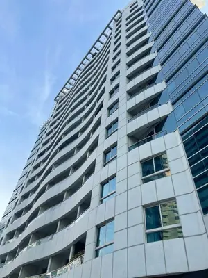 a tall building with many windows on the side of it at Diamond Tower Marina Apartment in Dubai