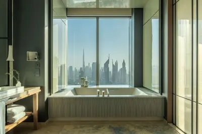a bathroom with a bath tub with a large window at One&Only One Za'abeel in Dubai