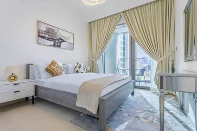 a bedroom with a bed and a large window at 3BR facing Dubai Mall 5 min walk to Burj Khalifa in Dubai
