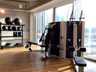 a fitness room with a gym with exercise equipment at 3BR facing Dubai Mall 5 min walk to Burj Khalifa in Dubai
