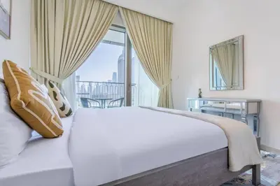 a bedroom with a large white bed and a window at 3BR facing Dubai Mall 5 min walk to Burj Khalifa in Dubai