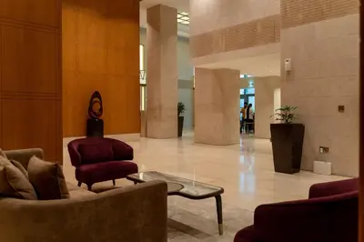 a lobby with a couch and a chair and a table at Bellavista - High Floor - 1BR 29 Boulevard - Burj Khalifa & Fountain View in Dubai
