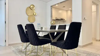 a dining room with a table and black chairs at Spacious 2 bedroom in Madinat Jumeirah Living in Dubai