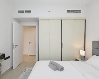 a bedroom with white walls and a white bed at Spacious 2 bedroom in Madinat Jumeirah Living in Dubai