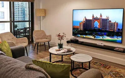 a living room with a large flat screen tv at La Buena Vida Holiday Homes - Deluxe, very spacious 5 Bedroom plus maidroom in Best location of JBR, Near to Beach, Marina and Tram station in Dubai