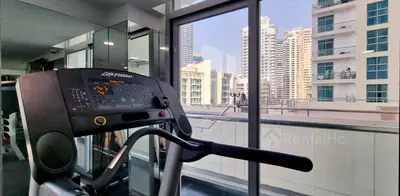 a gym with a view of a city from a building at 50% OFF Summer Offert, Nice w/ Balcony & Pool View in Dubai