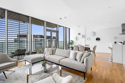a living room with a couch and a table at New 2 bedroom in Bluewaters with Direct Sea View in Dubai