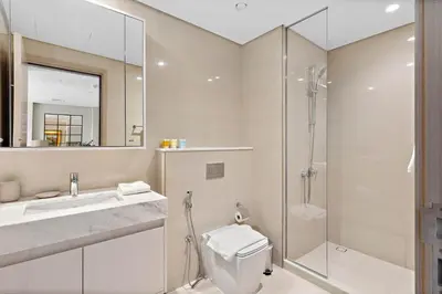 a bathroom with a shower and a toilet and a sink at Silkhaus sophisticated 1BDR in Downtown premium tower in Dubai