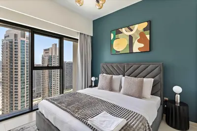 a bedroom with a large bed with a large window at Silkhaus sophisticated 1BDR in Downtown premium tower in Dubai