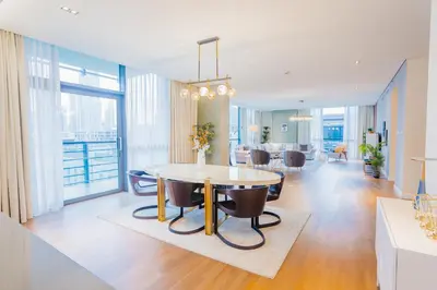 a dining room and living room with a table and chairs at Nasma Luxury Stays - City Walk Building 5 in Dubai