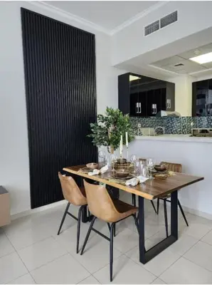 a dining room with a wooden table and chairs at Nasma Luxury Stays - Marina-View Oasis With Balcony Steps From The Sea in Dubai