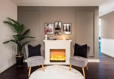 a living room with two chairs and a fireplace at Nasma Luxury Stays - Limestone House in Dubai
