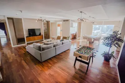 a living room with a couch and a table at Nasma Luxury Stays - Limestone House in Dubai