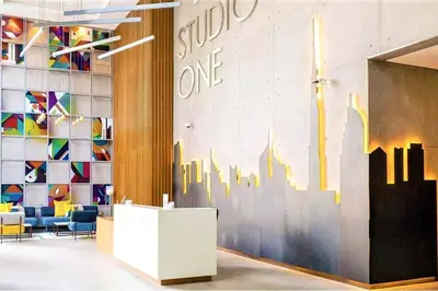 a lobby with a wall mural of a city at Cosy & Chic Studio One Marina with balcony & View in Dubai