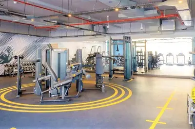 a gym with several treadmills and machines at Cosy & Chic Studio One Marina with balcony & View in Dubai