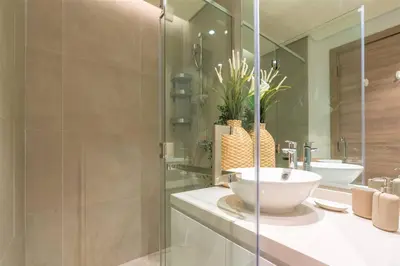 a bathroom with a sink and a glass shower at Cosy & Chic Studio One Marina with balcony & View in Dubai