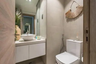 a bathroom with a toilet and a sink and a mirror at Cosy & Chic Studio One Marina with balcony & View in Dubai