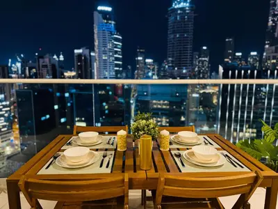 a wooden table with chairs and a view of the city at In the heart of Business Bay - Bills included in Dubai