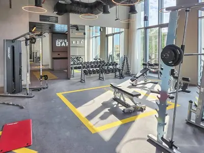 a gym with rows of treadmills and machines at Vogue Creek Harbour The Grand Waterfront Living close to Downtown, Burj Khalifa and Dubai Mall, Two Bedroom Apartment with Balcony, Canal and Vibrant Community View, Access to all Amenities in Dubai