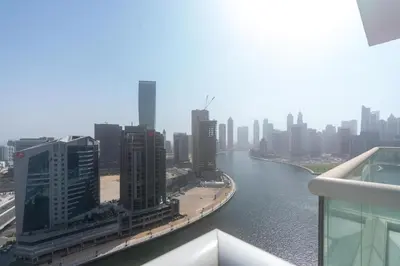 a view of a river in a city with tall buildings at Gala Guests - Maison Prive Canal View Collection in Dubai