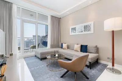 a living room with a couch and a table at Gala Guests - Maison Prive Canal View Collection in Dubai