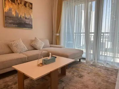 a living room with a couch and a coffee table at ROYAL APARTMENTS DUBAI in Dubai