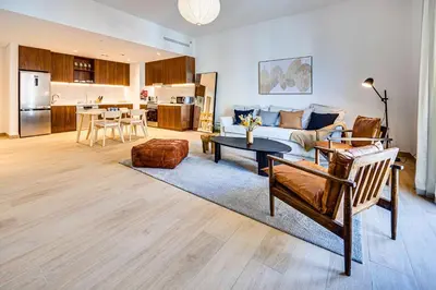 a living room with a couch and a table at Amazing 1BD sea view apartment in Port de La Mer in Dubai