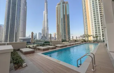 a swimming pool on the roof of a building with tall buildings at Maison Privee - Luxury 2Bedroom with Burj Khalifa & Fountain Views in Dubai