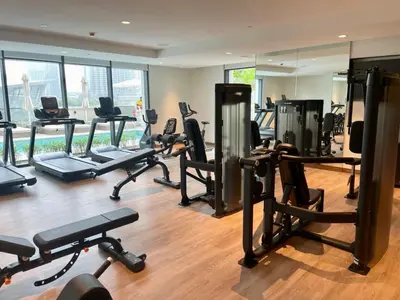 a gym with a lot of treadmills and exercise bikes at Maison Privee - Luxury 2Bedroom with Burj Khalifa & Fountain Views in Dubai