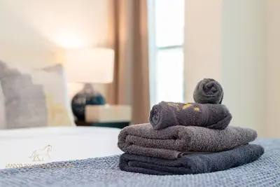 a pile of towels sitting on top of a bed at Marco Polo - Enjoy comfort and class near Burj Khalifa in Dubai