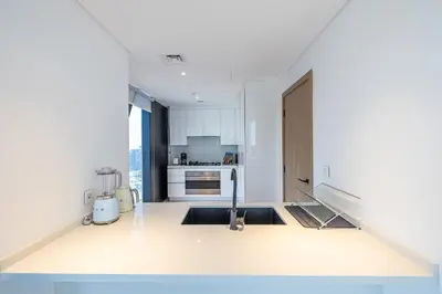 a kitchen with a sink and a stove top oven at 3BDR Apartment with Maid Room and Burj Khalifa View in Dubai