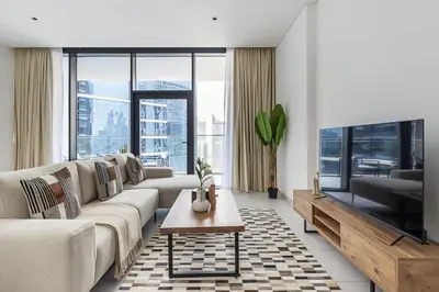 a living room with a couch and a tv at Frank Porter - Marquise Square Tower in Dubai