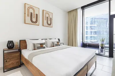 a bedroom with a large bed and a large window at Frank Porter - Marquise Square Tower in Dubai