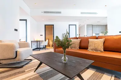 a living room with a couch and a table at Contemporary Ranch Living with Burj Khalifa View in Dubai