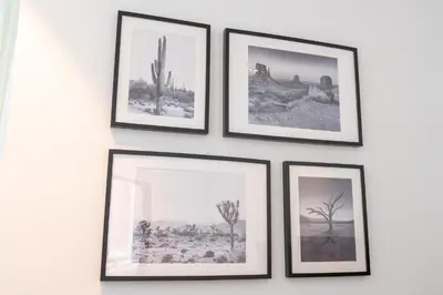 a group of framed pictures hanging on a wall at Contemporary Ranch Living with Burj Khalifa View in Dubai